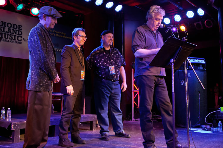The late Randy Hien, founder of The Living Room and a tireless advocate for Rhode Island’s original music scene, was inducted with a heartfelt tribute by The Schemers: Dick Reed, Mark Cutler, Jim Berger & Emerson Torrey at the microphone